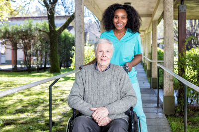 senior man on a wheelchair with his caregiver